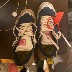 A pair of off white sneakers